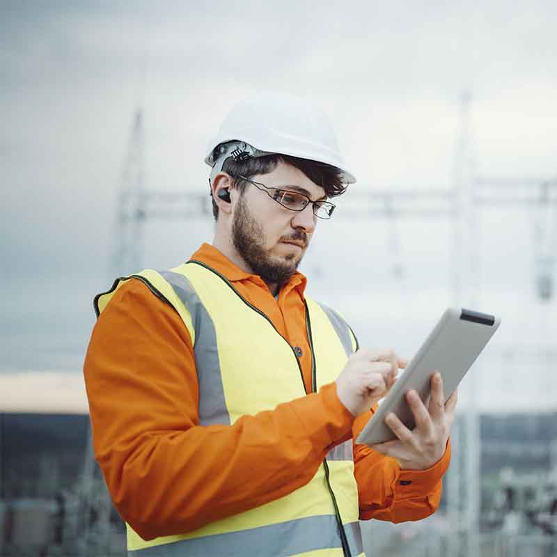 Construction worker wearing bluetooth hearing protection. 